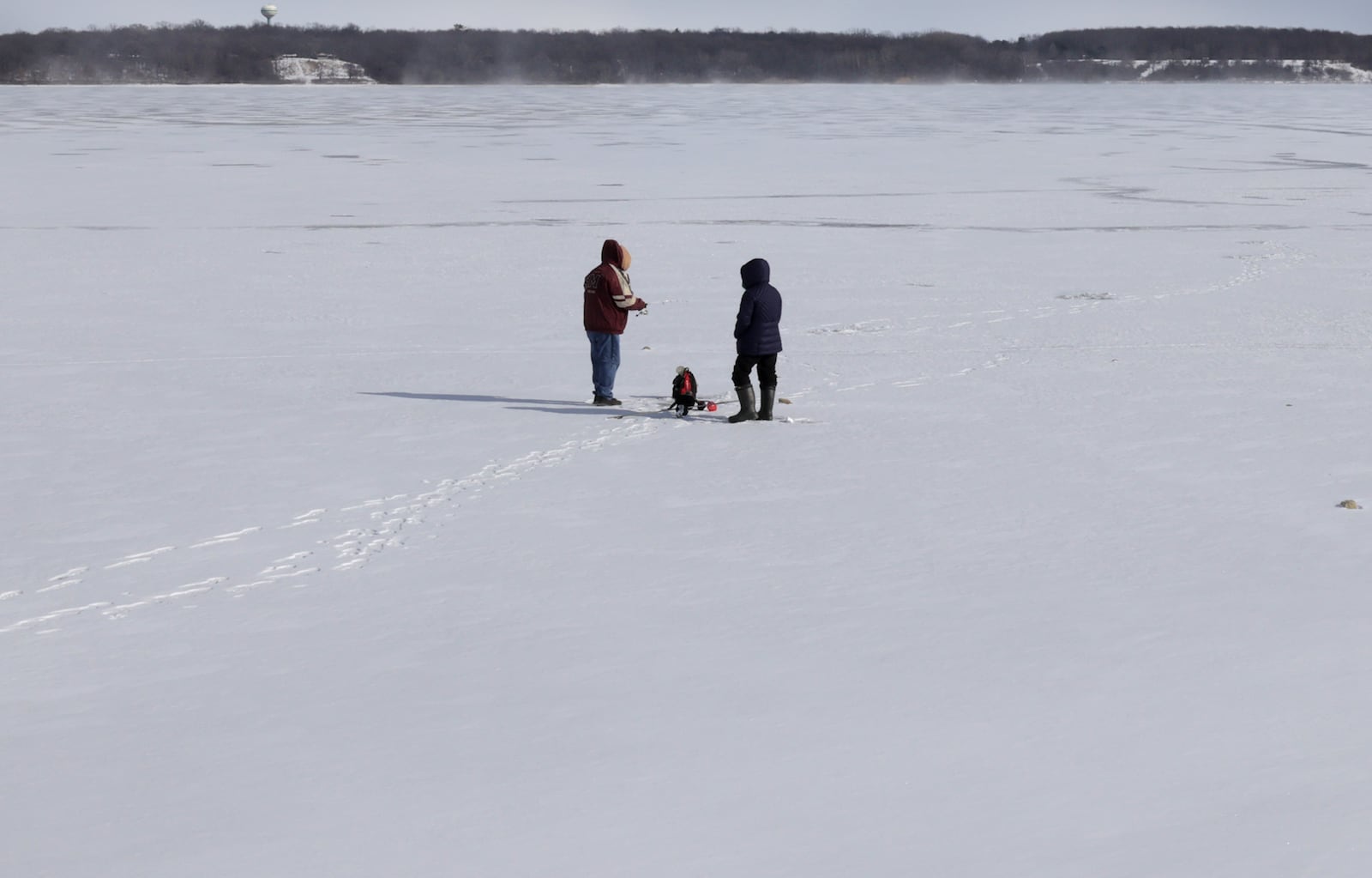 Two ice fishermen stand on several inches of ice covering C.J. Brown Reservoir Tuesday, Jan. 21, 2025 at Buck Creek State Park. BILL LACKEY/STAFF