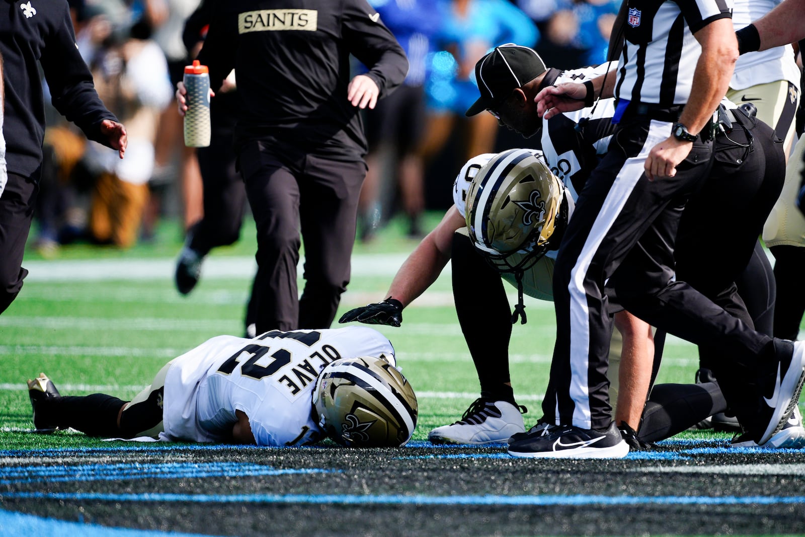 New Orleans Saints wide receiver Chris Olave in comforted by wide receiver Deven Thompkins during the first half of an NFL football game against the Carolina Panthers Sunday, Nov. 3, 2024, in Charlotte, N.C. Olave was taken off the field after getting hurt on the play. (AP Photo/Jacob Kupferman)