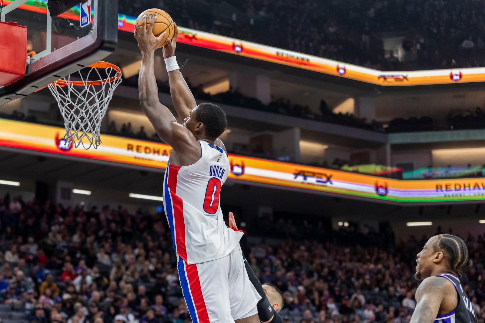 Detroit Pistons center Jalen Duren, left, dunks on a fast break during the first half of an NBA basketball game against the Sacramento Kings, Thursday, Dec. 26, 2024, in Sacramento, Calif. (AP Photo/Sara Nevis)