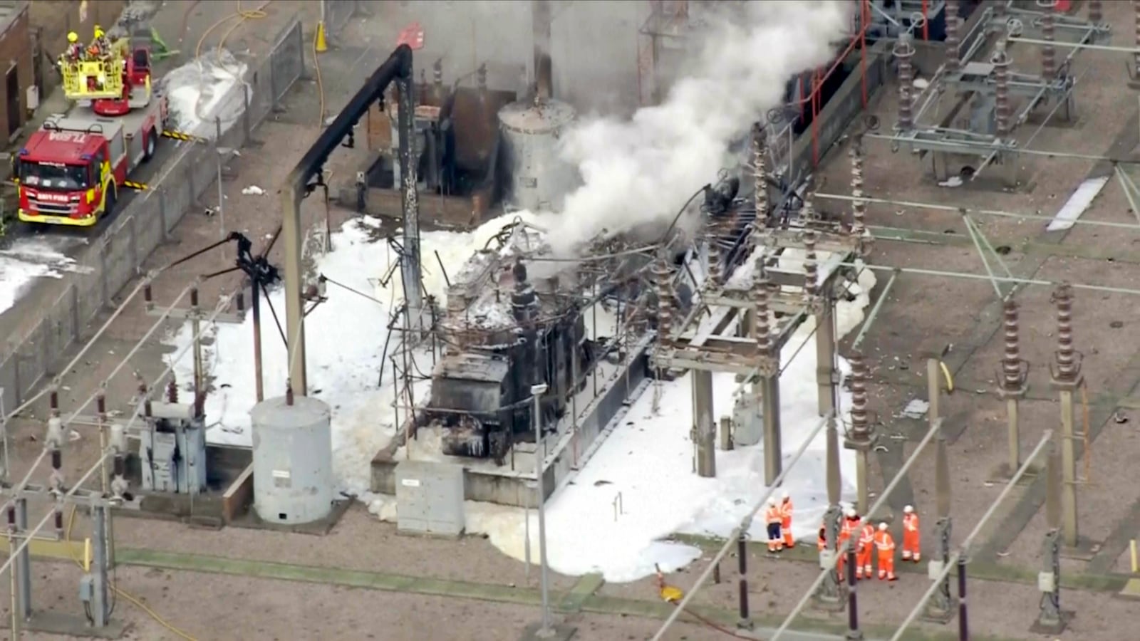 This image taken from video shows firefighters working to secure the area of a fire at the North Hyde electrical substation, which caught fire Thursday night and lead to a closure of Heathrow Airport in London, Friday, March 21, 2025. (Sky News via AP)