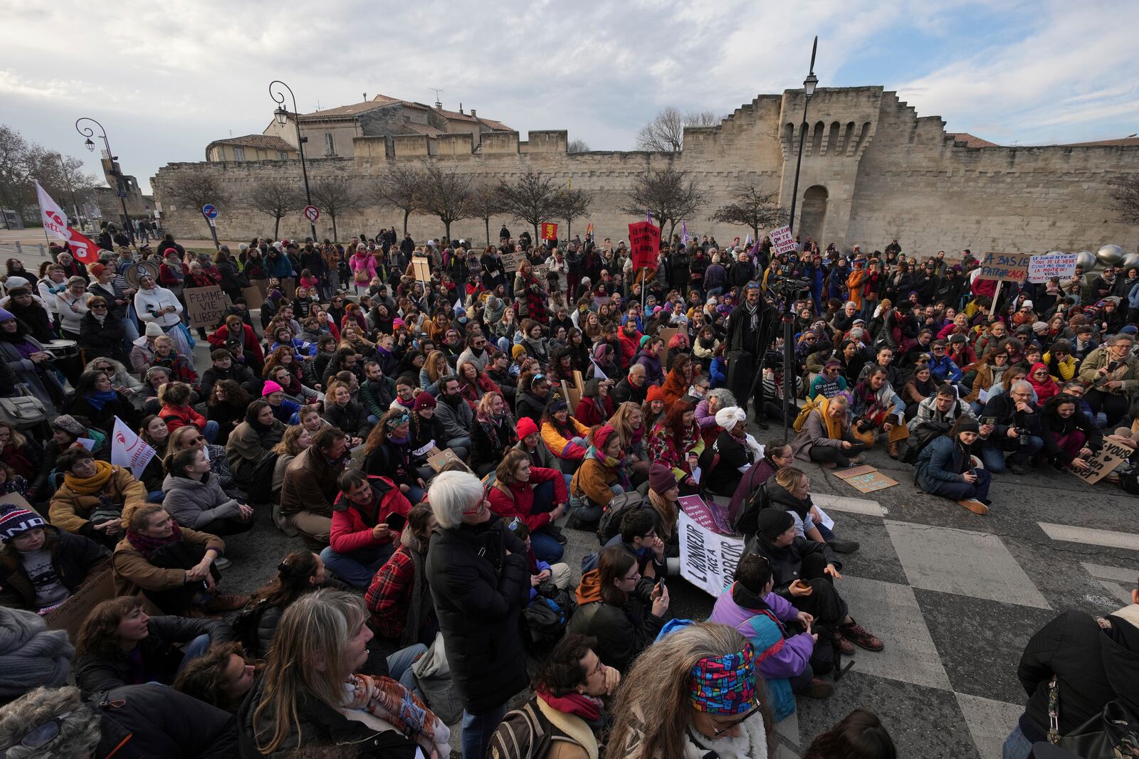 FILE - Activists gather during a women's rights demonstration, Dec. 14, 2024, in Avignon, southern France, where the trial of dozens of men accused of raping Gisèle Pelicot while she was drugged and rendered unconscious by her husband is taking place. (AP Photo/Aurelien Morissard, File)