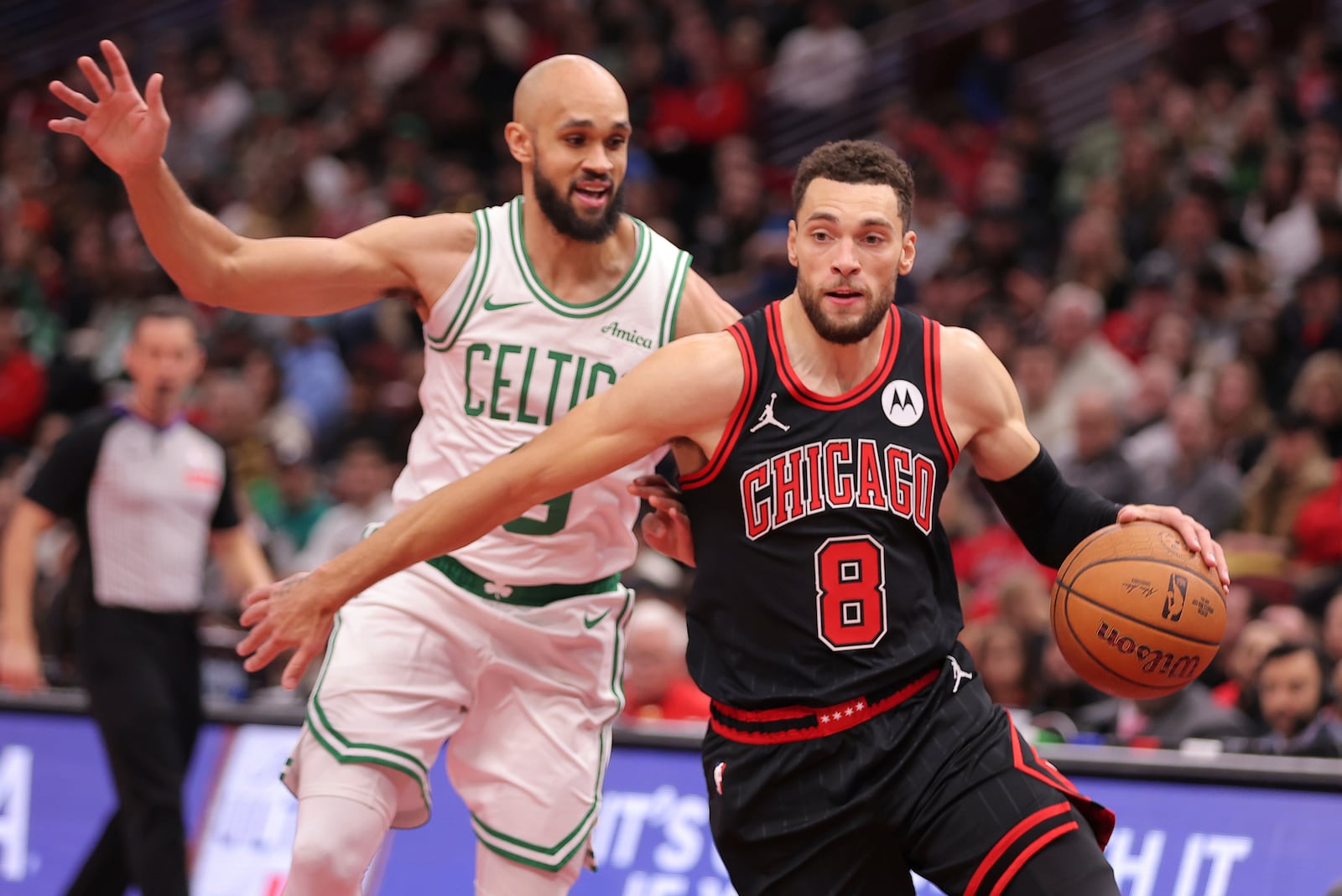 Chicago Bulls guard Zach LaVine drives to the basket past Boston Celtics guard Derrick White during the first half of an Emirates NBA Cup basketball game, Friday Nov. 29, 2024, in Chicago. (AP Photo/Melissa Tamez)