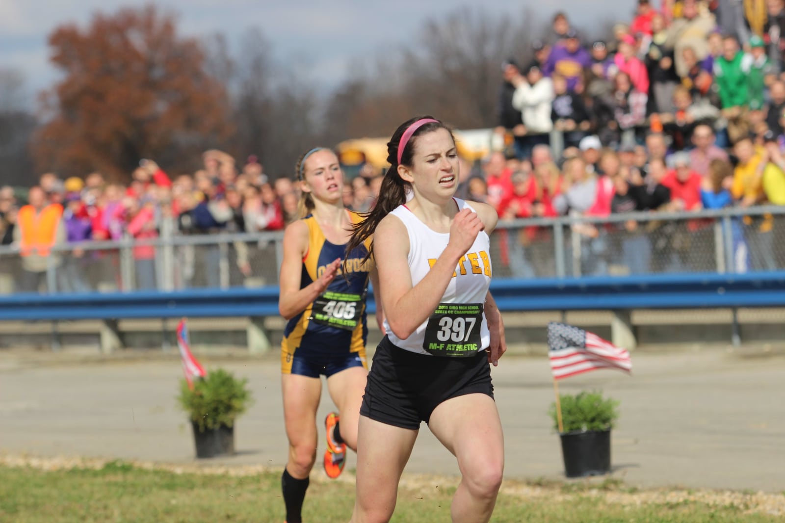 Alter senior Abby Nichols holds off Oakwood senior Mary Kate Vaughn to win the Division II state cross country championship Saturday. Staff photo by Greg Billing