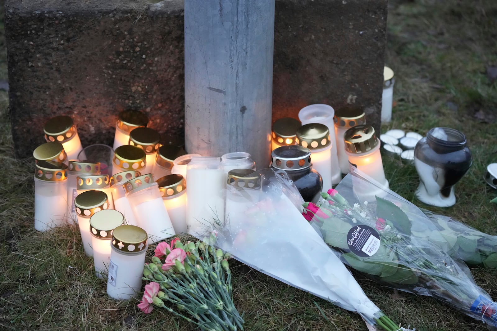 Candles and flowers are placed at a makeshift memorial near the scene of a shooting at an adult education center on the outskirts of Orebro, Sweden, Wednesday, Feb. 5, 2025. (AP Photo/Sergei Grits)