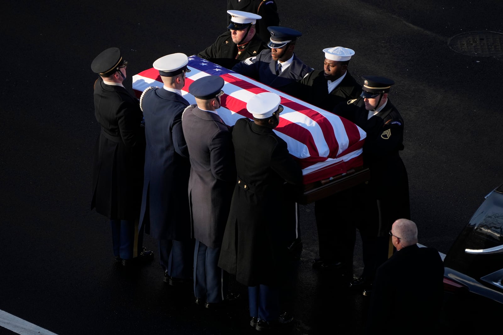 The flag-draped casket of former President Jimmy Carter is transferred to a horse-drawn caisson at the U.S. Navy Memorial before traveling on to the Capitol in Washington, Tuesday, Jan. 7, 2025, where Carter will lie in state. Carter died Dec. 29 at the age of 100. (AP Photo/Mark Schiefelbein, Pool)