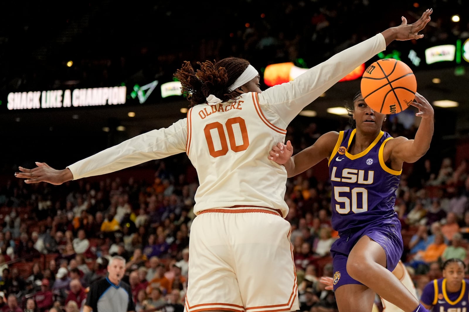 LSU guard Shayeann Day-Wilson passes around Texas forward Kyla Oldacre during the first half during of an NCAA college basketball game in the semifinals of the Southeastern Conference tournament, Saturday, March 8, 2025, in Greenville, S.C. (AP Photo/Chris Carlson)