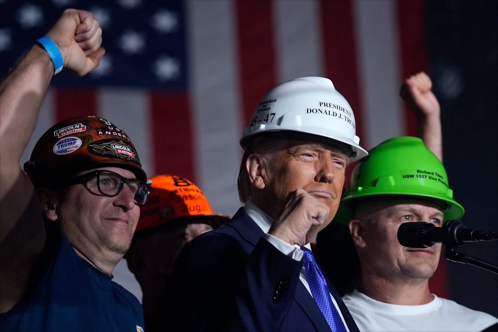 Republican presidential nominee former President Donald Trump stands on stage with steelworkers as he speaks during a campaign rally at Arnold Palmer Regional Airport, Saturday, Oct. 19, 2024, in Latrobe, Pa. (AP Photo/Evan Vucci)