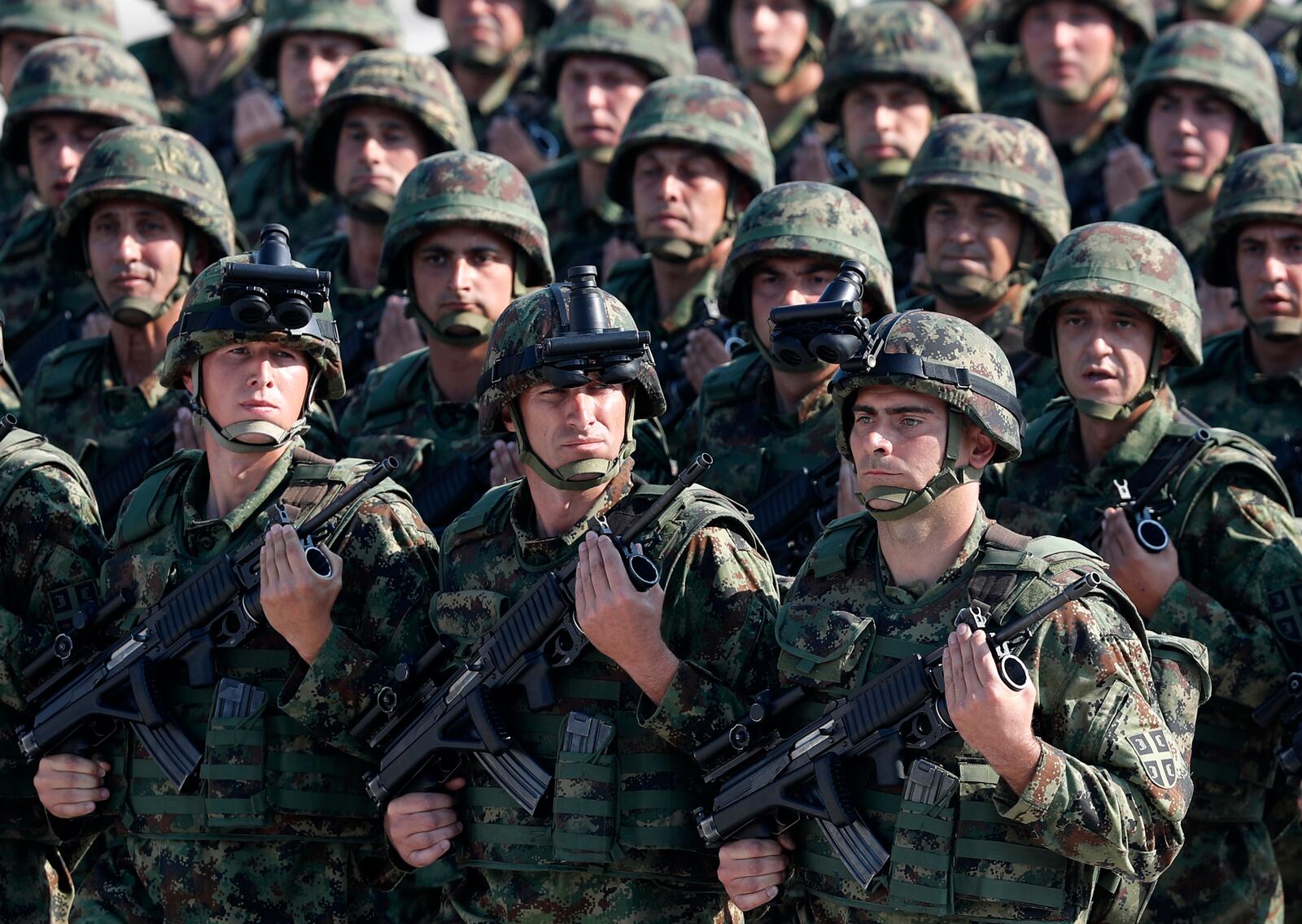 In this photo taken Saturday, Oct. 19, 2019, Serbian Army soldiers perform during a military parade at the military airport Batajnica, near Belgrade, Serbia. Citing alleged pressure from the West, Serbia has suspended all foreign military exercises ahead of the planned maneuvers with Russia and Belarus. (AP Photo/Darko Vojinovic)