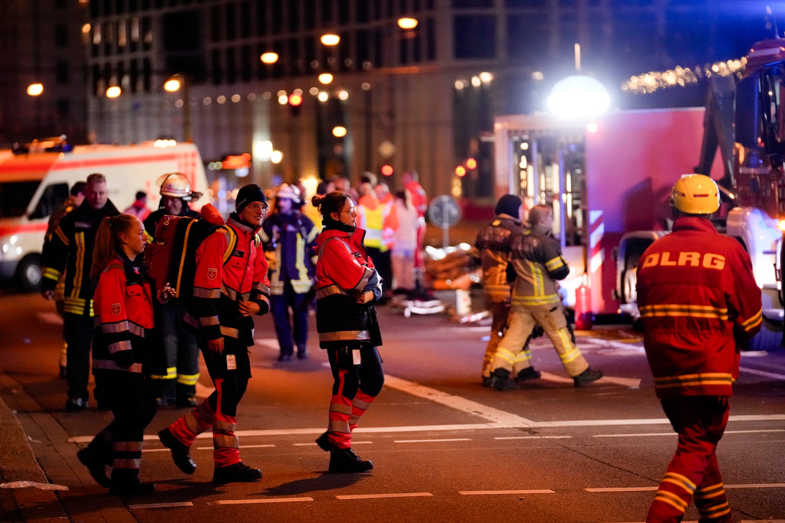 Emergency services work in a cordoned-off area near a Christmas Market, after a car drove into a crowd in Magdeburg, Germany, Friday, Dec. 20, 2024. (AP Photo/Ebrahim Noroozi)