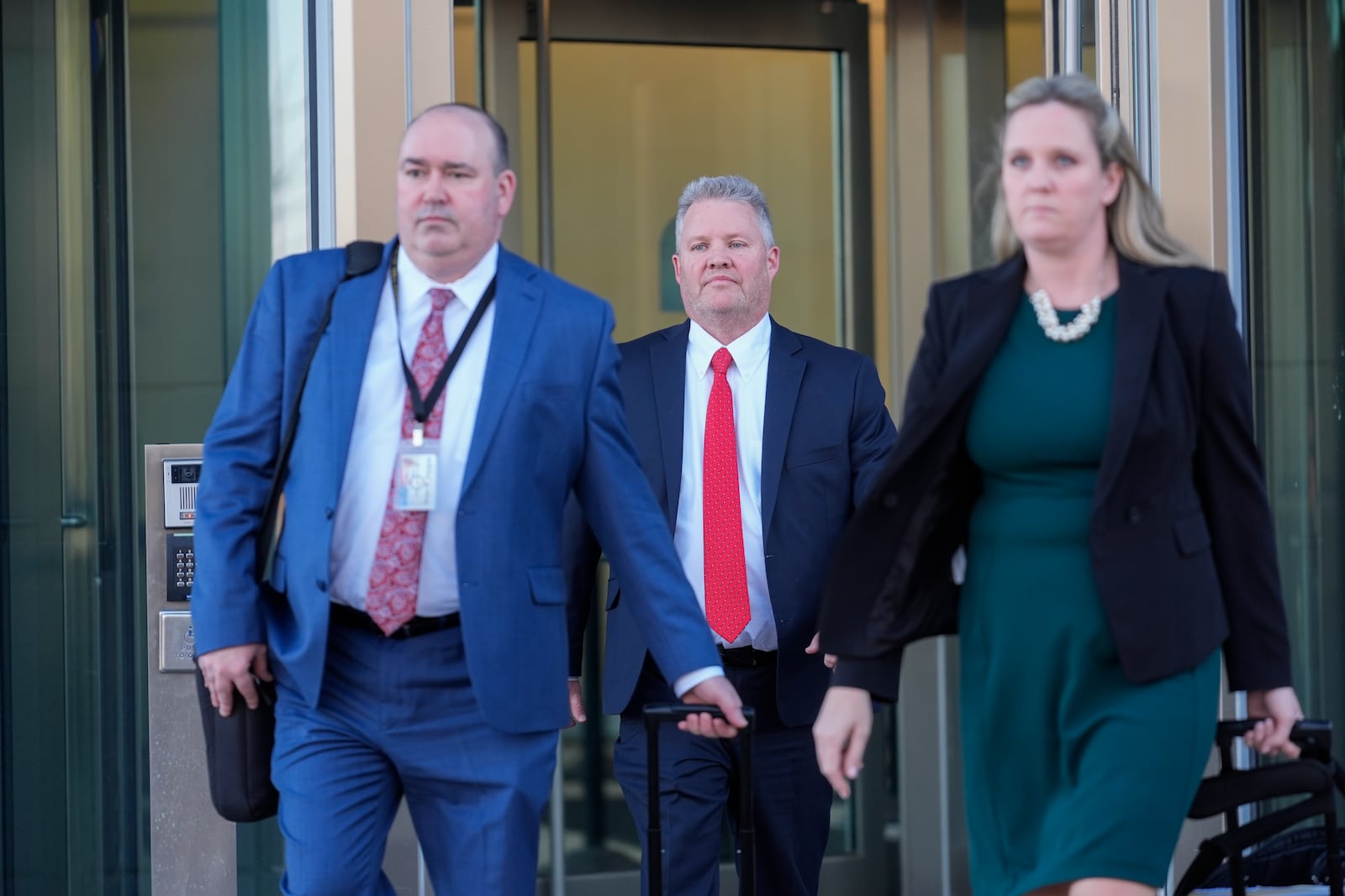 From left, Will County State's attorneys Christopher Koch, Michael Fitzgerald and Christine Vukmir leave the Will County Courhouse after the first day of the trial of Joseph Czuba, 73, who is charged with the fatal stabbing of six-year-old Palestinian boy Wadee Alfayoumiand and the wounding of his mother Hanan Shaheen, Tuesday, Feb. 25, 2025, in Joliet, Ill. (AP Photo/Erin Hooley)