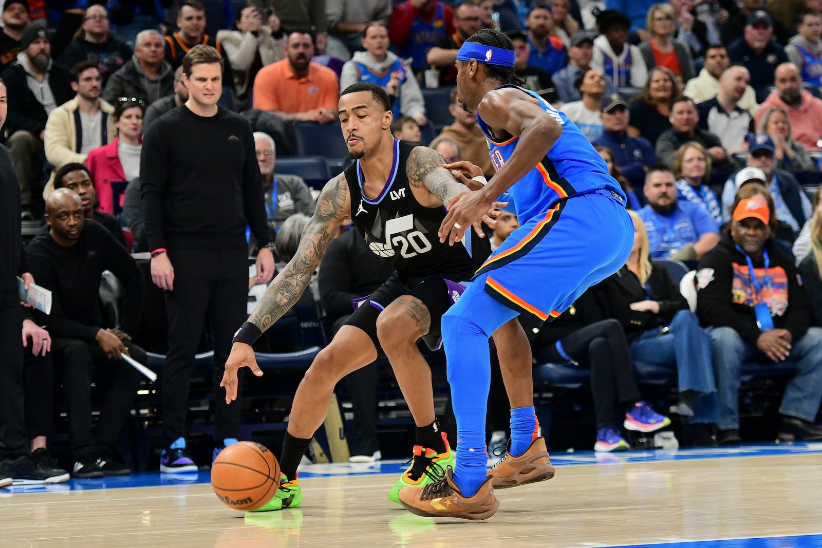 Utah Jazz forward John Collins, left, pushes past Oklahoma City Thunder guard Shai Gilgeous-Alexander during the second half of an NBA basketball game, Wednesday, Jan. 22, 2025, in Oklahoma City. (AP Photo/Kyle Phillips)