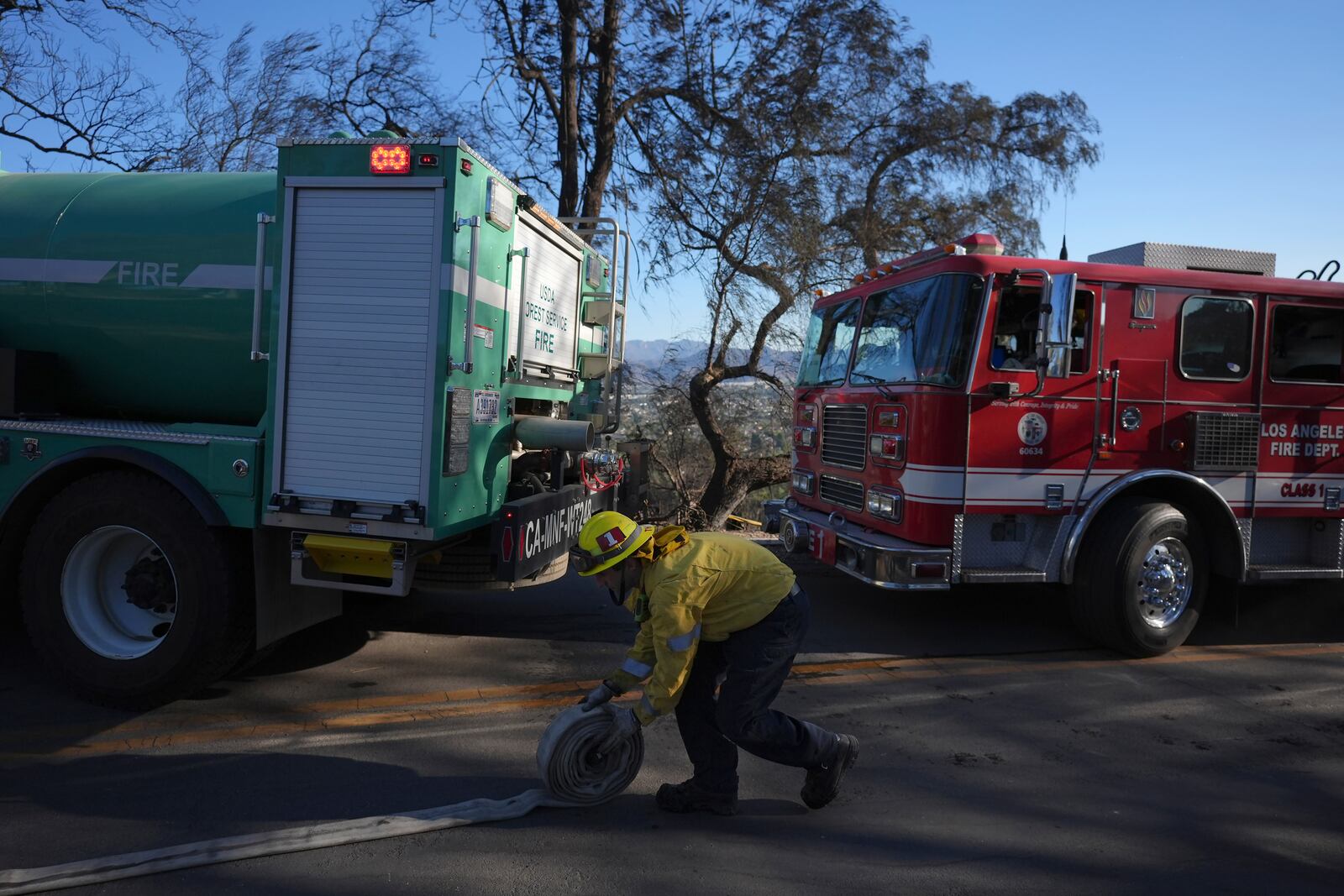 A Los Angeles Fire Department firefighter works near homes destroyed by the Mountain Fire in Camarillo, Calif., Friday, Nov. 8, 2024. (AP Photo/Jae C. Hong)