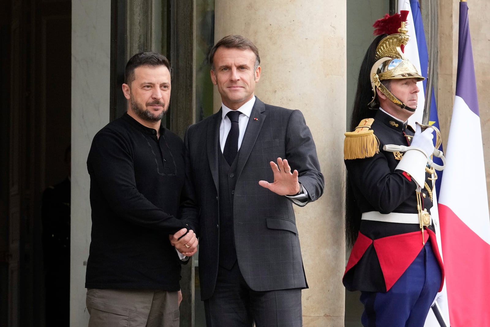 French President Emmanuel Macron, right, welcomes his Ukrainian counterpart Volodymyr Zelenskyy before a meeting at the Elysee Palace, in Paris, Thursday, Oct. 10, 2024. (AP Photo/Michel Euler)