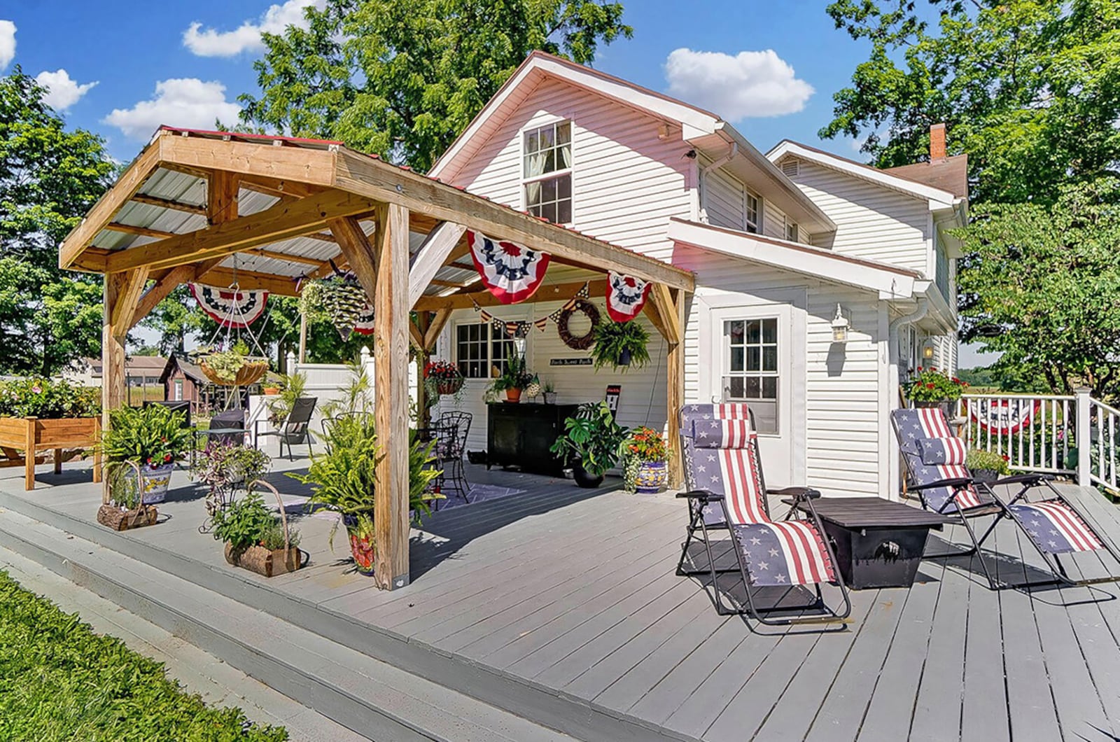 The rear of the home has a partially covered deck, a firepit and a hot tub area surrounded by a wood privacy fence. CONTRIBUTED PHOTO