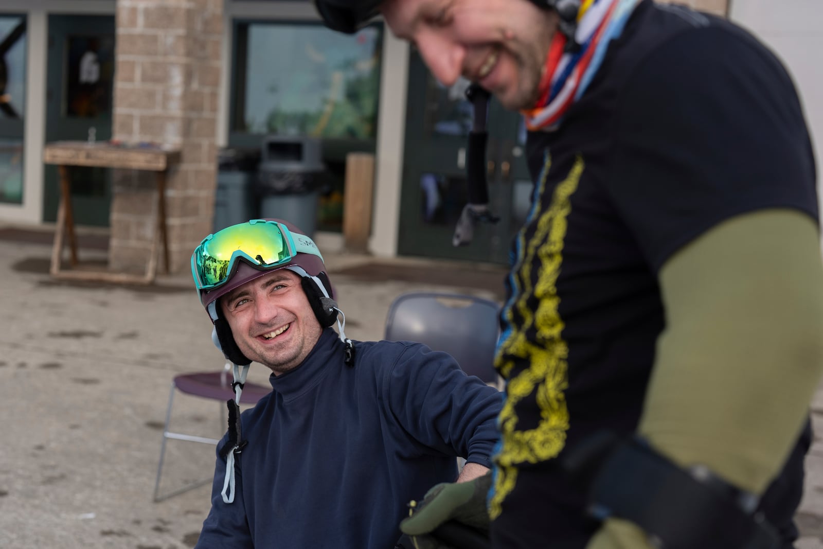 Ukrainian veterans Mikhailo Danylo, left, and Artem Pogorilyi laugh after a lesson with Oregon Adaptive Sports on the three track skiing method at Hoodoo Ski Area in central Oregon on Thursday, March 6, 2025. (AP Photo/Jenny Kane)