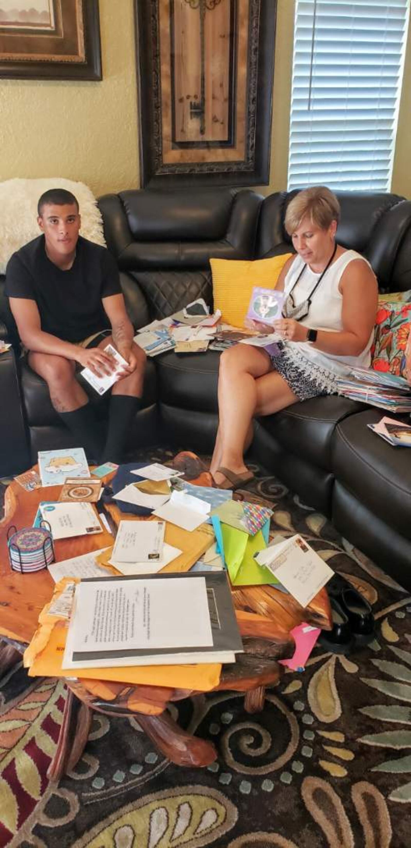 Brooks Lyle and his mother, Deb Lyle, open cards, letters and packages sent do Brooks, who spent his 20th birthday on Sept. 11 in Air Force basic training.