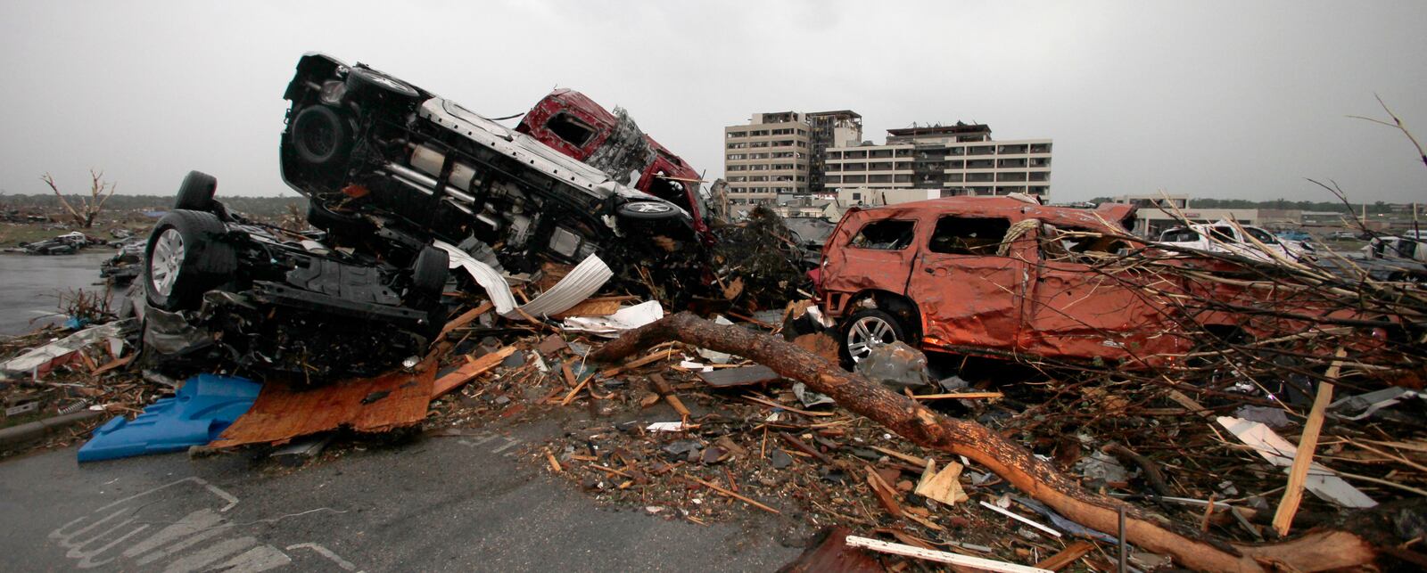 FILE- Cars litter the parking lot at the damaged St. John's Regional Medical Center in Joplin, Mo., Monday, May 23, 2011. (AP Photo/Charlie Riedel, File)