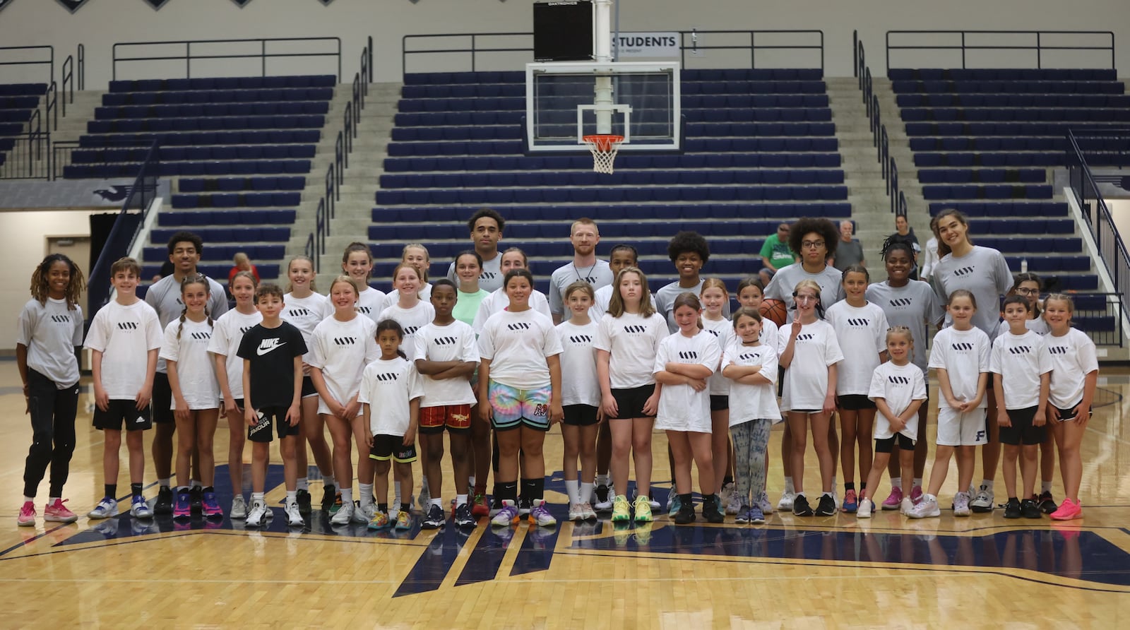 Coaches and kids pose for a photo at the Maddy Westbeld Basketball Clinic on Friday, June 7, 2024, at Trent Arena in Kettering. David Jablonski/Staff