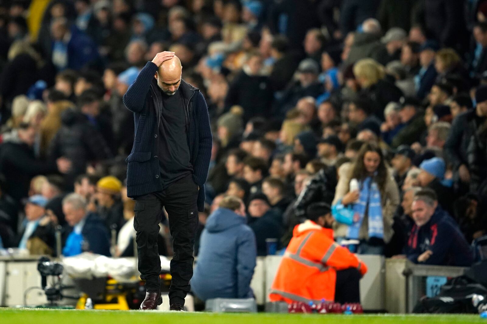 Manchester City's head coach Pep Guardiola reacts during the English Premier League soccer match between Manchester City and Manchester United at the Etihad Stadium in Manchester, Sunday, Dec. 15, 2024. (AP Photo/Dave Thompson)