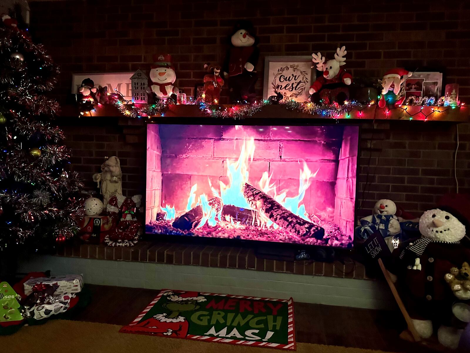 The family room features a fireplace. Alicia Erwin creatively mounted the TV screen under the mantel. With a YouTube video of a crackling fire playing, a guest can almost feel the warmth of the flames. ROBIN MCMACKEN/PHOTO