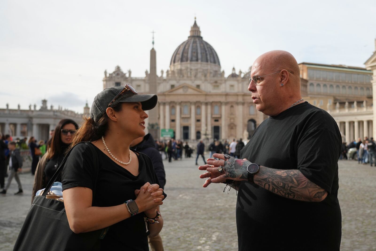 Jose Enrique Escardo, a victim of Peru's Sodalitium Christianae Vitae movement, right, shares a smile with his friend Brisa De Angulo, executive director of the association, A Breeze of Hope before an interview with the Associated Press in front of St. Peter's Basilica, in Rome, Saturday, Jan. 25, 2025. (AP Photo/Alessandra Tarantino)