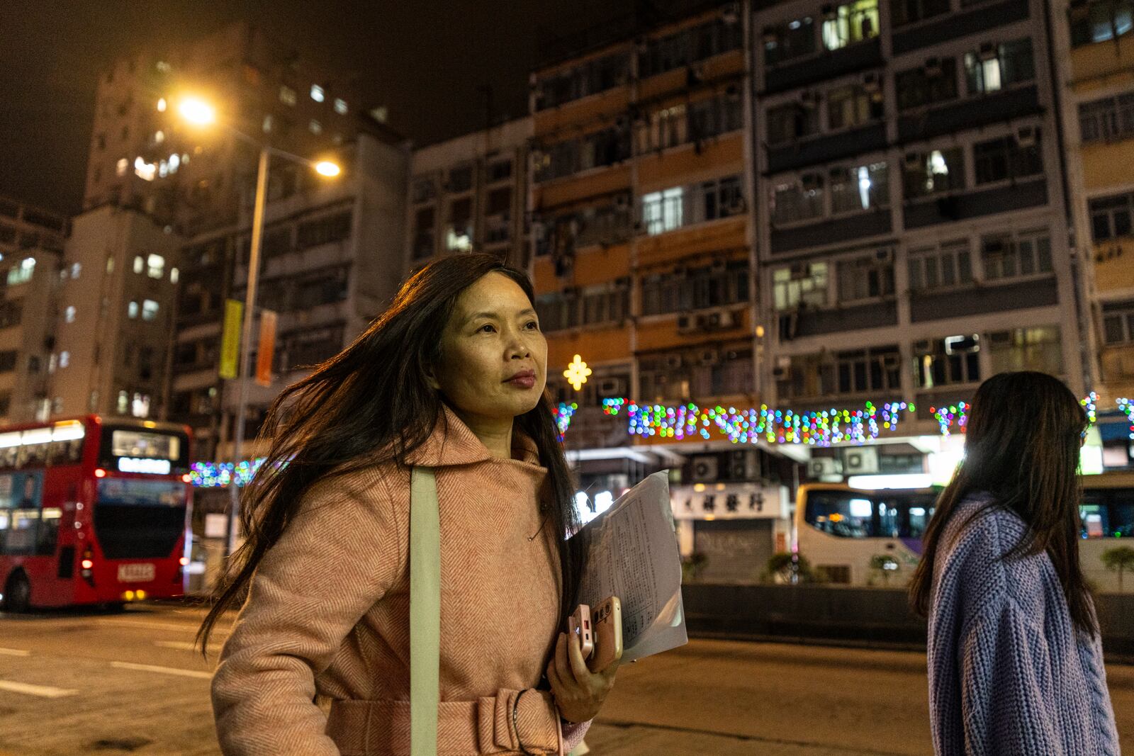 Sze Lai-shan, the deputy director of the Society for Community Organization, walks on her way to visit residents in the subdivided flat in Sham Shui Po district of Hong Kong, on Feb. 6, 2025. (AP Photo/Chan Long Hei)