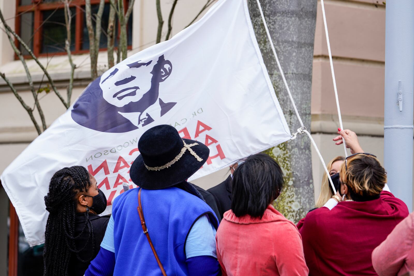 FILE - Mayor Rick Kriseman, city officials and community leaders mark the start of Black History Month during a ceremonial raising of the Dr. Carter G. Woodson African American Museum flag in front of St. Petersburg City Hall, Feb. 1, 2021, in St. Petersburg, Fla. (Martha Asencio Rhine/Tampa Bay Times via AP)