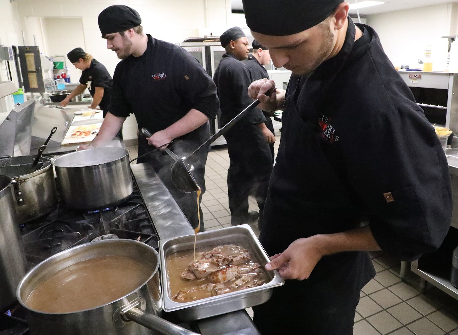 Senior Culinary Arts student Andrew Dyar cooking in the kitchen with the other students getting ready for the lunch crowd at the Jaguar Room. BILL LACKEY/STAFF