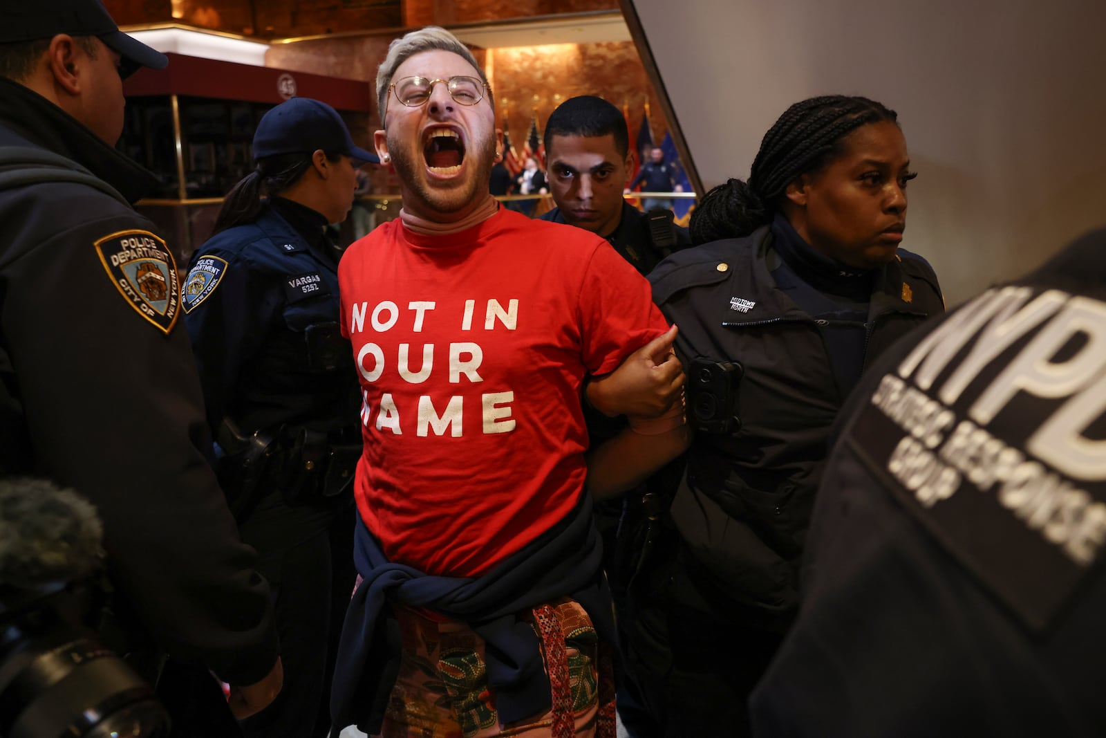 New York Police officers arrest a demonstrator from the group, Jewish Voice for Peace, who protested inside Trump Tower in support of Columbia graduate student Mahmoud Khalil, Thursday, March 13, 2025, in New York. (AP Photo/Yuki Iwamura)