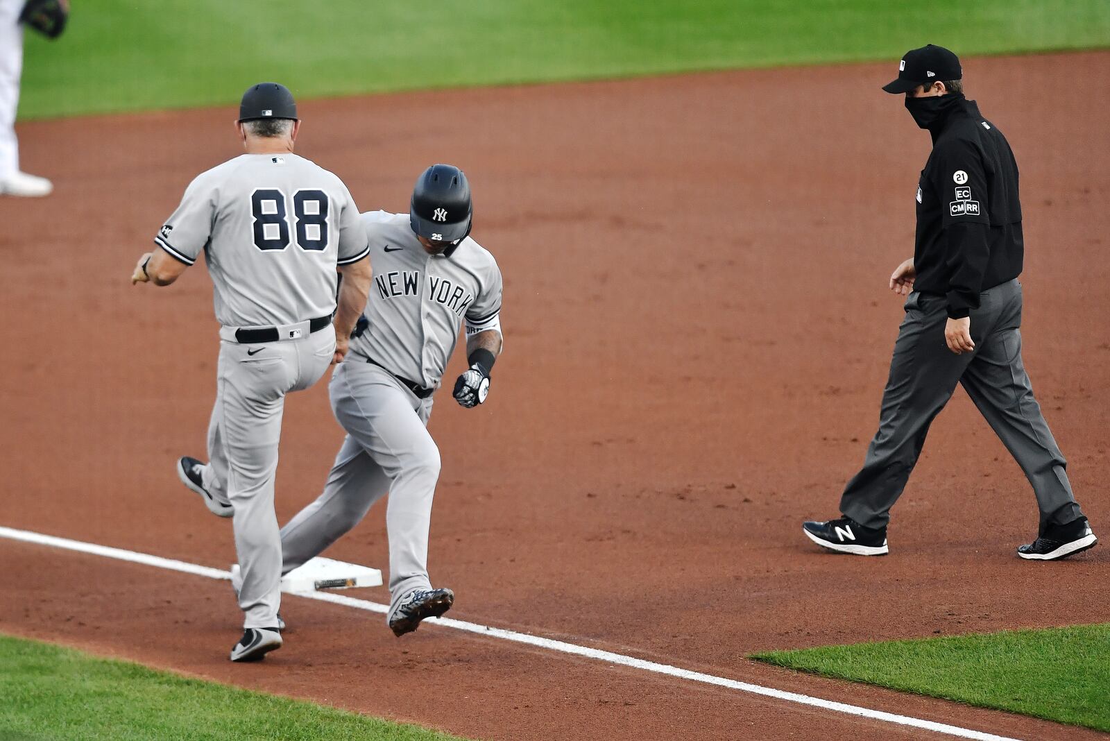 New York Yankees' Gleyber Torres celebrates with third base coach Phil Nevin (88) after hitting a solo home run against the Toronto Blue Jays during the second inning of a baseball game in Buffalo, N.Y., Wednesday, Sept. 9, 2020. (AP Photo/Adrian Kraus)