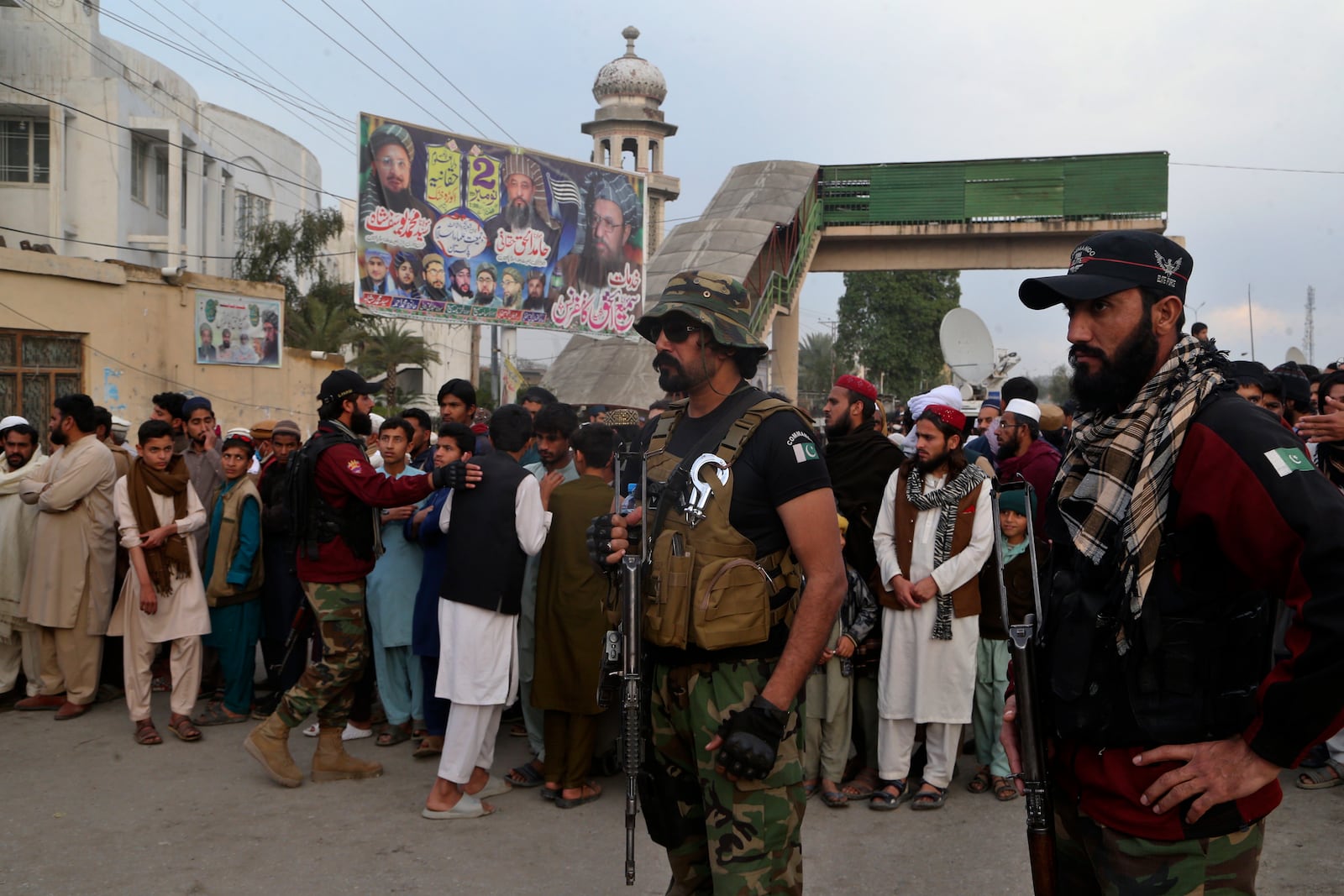 Police officers control crowd gather outside a pro-Taliban seminary 'Darul Uloom Haqqania' following a suicide bombing in a mosque, in Akora Khattak, a district in the Pakistan's northwestern Khyber Pakhtunkhwa province, Friday, Feb. 28, 2025. (AP Photo/Muhammad Sajjad)