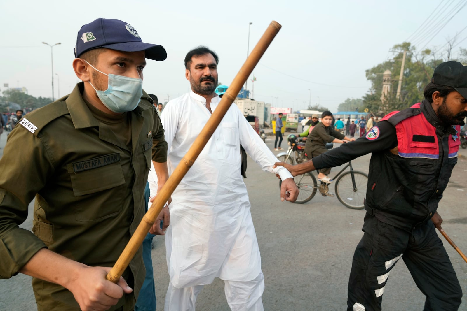 Police officers detain a supporter of imprisoned former premier Imran Khan's Pakistan Tehreek-e-Insaf party, which supporters gather for a rally demanding Khan's release, in Lahore, Pakistan, Sunday, Nov. 24, 2024. (AP Photo/K.M. Chaudary)