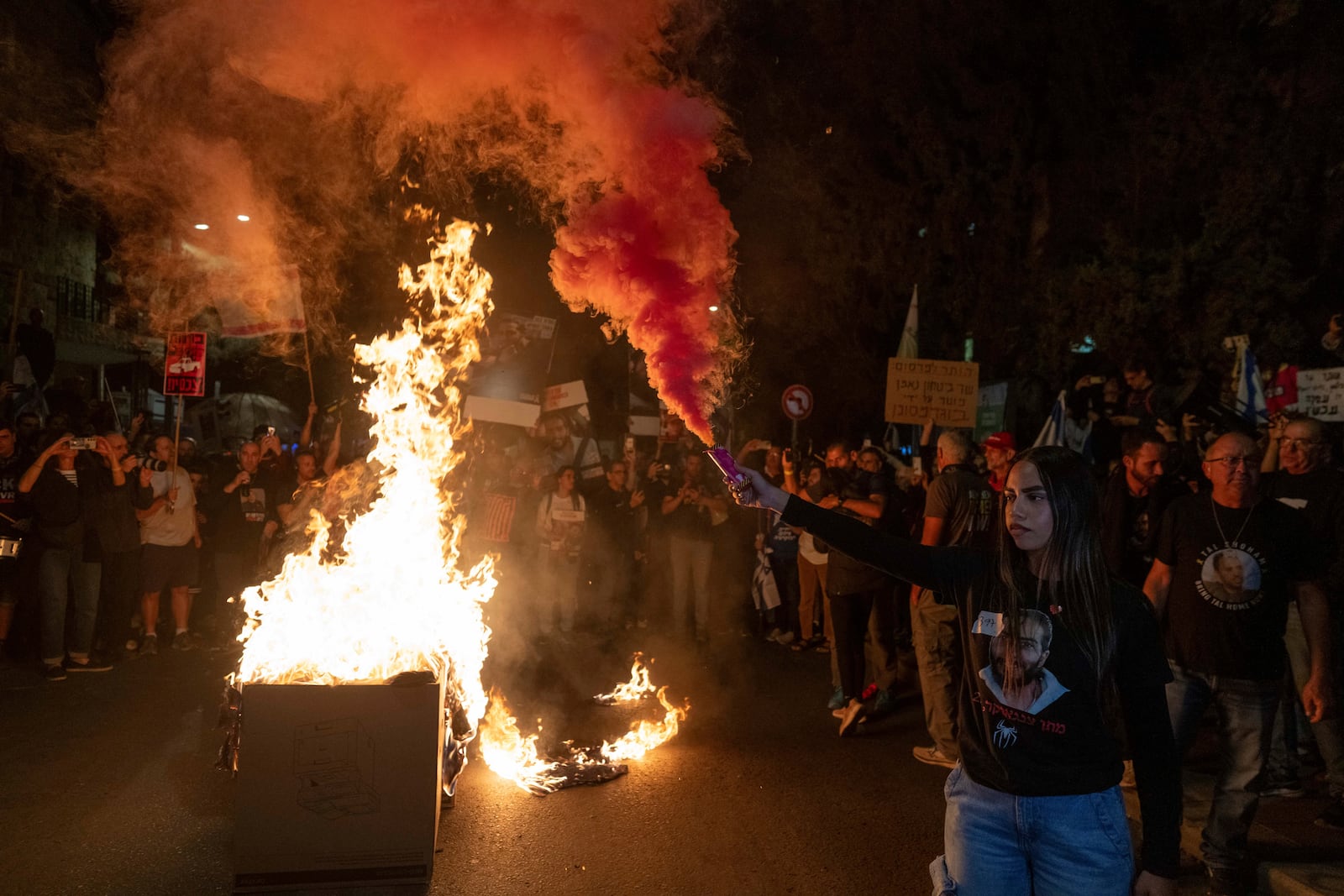 Israelis light a bonfire during a protest against Prime Minister Benjamin Netanyahu near his residence in Jerusalem, a day after he dismissed his defence minister Yoav Gallant, Wednesday, Nov. 6, 2024. (AP Photo/Ohad Zwigenberg)