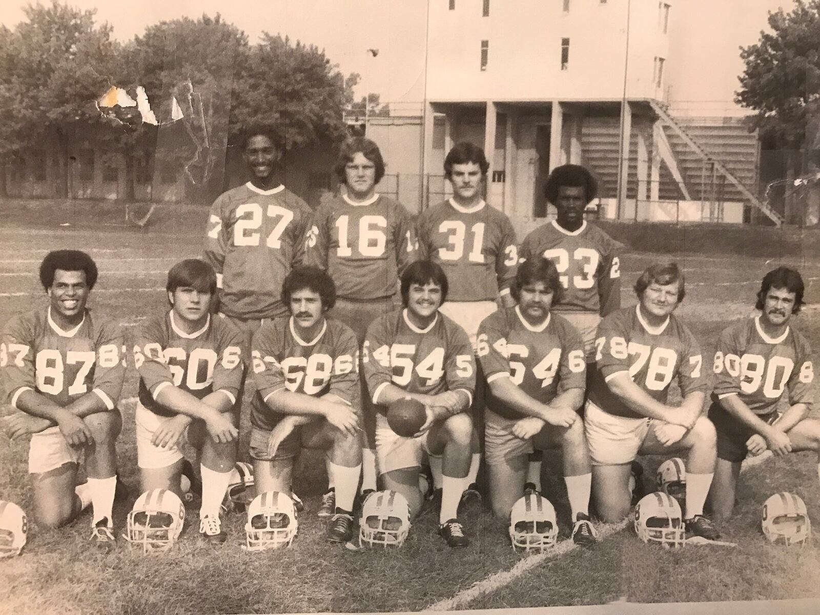 The starting offensive unit of Wittenberg’s 1973 national championship team. (Front row, left to right): tight end Eddie Edwards (87); tackle Steve Drongowski (60); guard Frank Dmach (68); center Tom Smigel (54); guard Mark LaForce (64); tackle Terry Merz (78); tight end/wide receiver John Kingsboro (80). (Back row left to right): receiver Bill Reid (27); quarterback Lloyd Ball (16); fullback Doug Jacobs (31); halfback Glenn Hendrix (23) Not pictured: tight end Lowell Harper. CONTRIBUTED