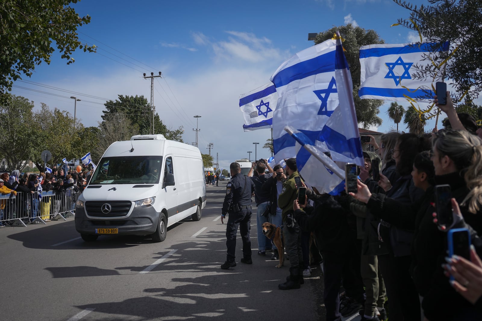 The convoy carrying the coffins of four Israeli hostages, including a mother and her two children, arrives at the Abu Kabir Forensic Institute in Tel Aviv, Israel, Thursday Feb. 20, 2025 after they were handed over by Palestinian militant groups in Gaza.(AP Photo/Ohad Zwigenberg)