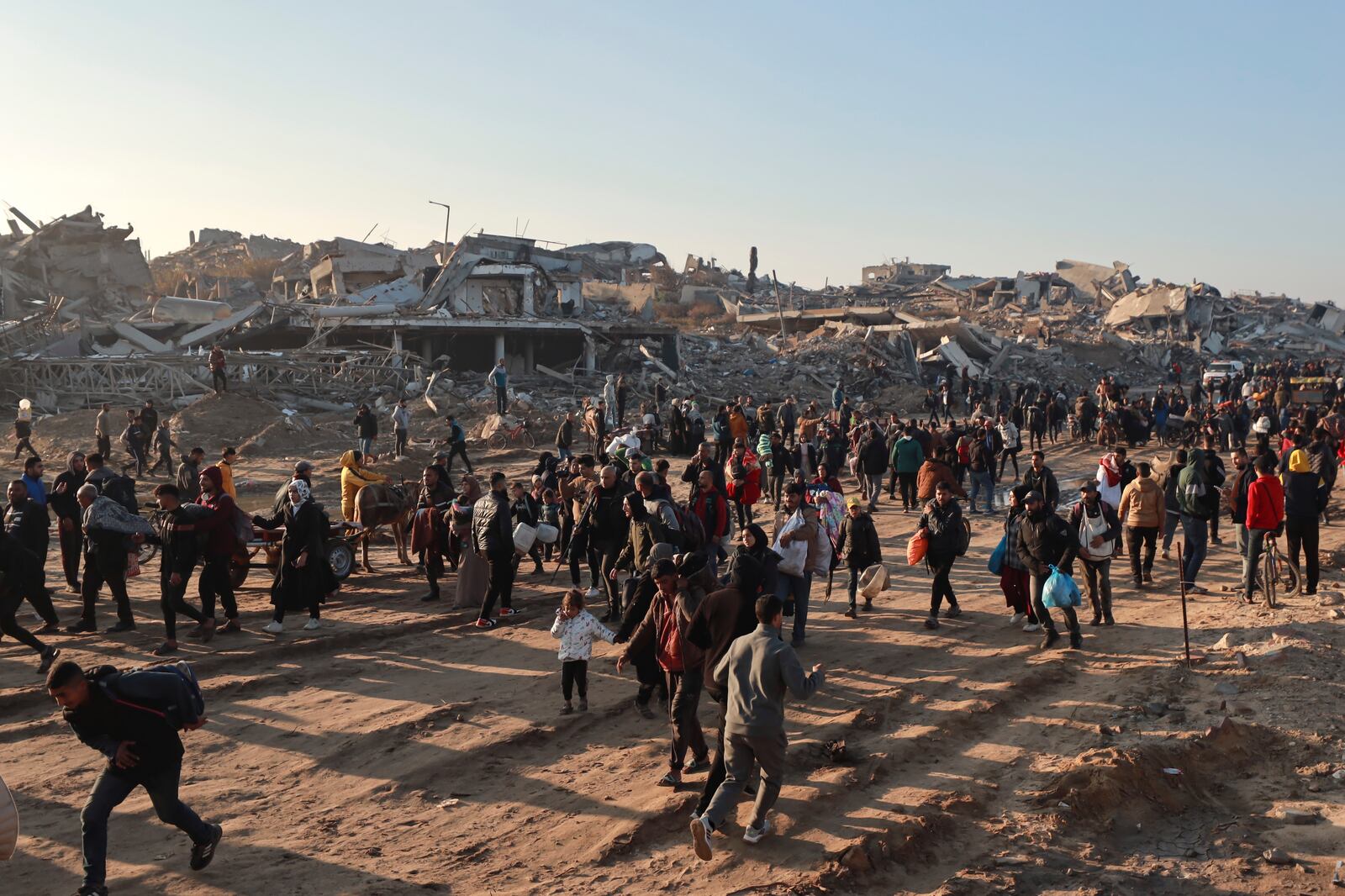 Displaced Palestinians arrive in the northern Gaza Strip, following Israel's decision to allow thousands of them to go back for the first time since the early weeks of the 15-month war with Hamas, Monday, Jan. 27, 2025. (AP Photo/Abed Hajjar)