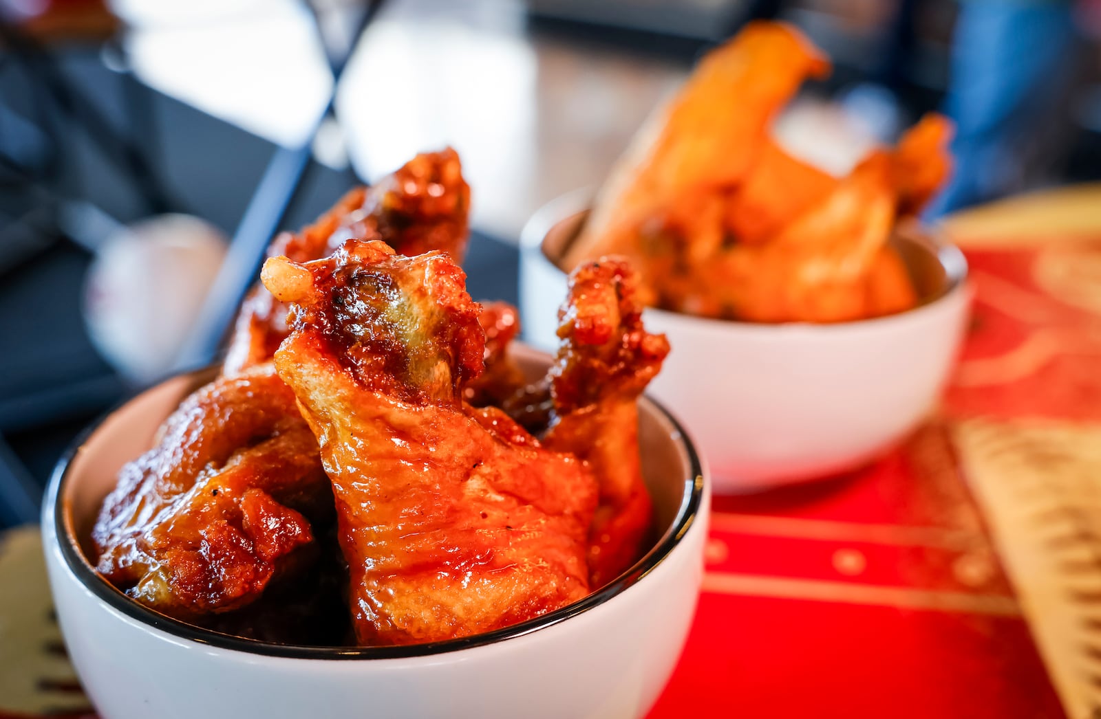 The Cincinnati Reds announced new menu items ahead of opening day on Friday, March 21, 2025 in The Handlebar at the Riverfront Club inside Great American Ball Park in Cincinnati. Executive Chef Gary Davis created a variety of new dishes for the upcoming season. This is the Wing and Rings traditional chicken wings with garlic medium or honey barbeque sauce.  NICK GRAHAM/STAFF