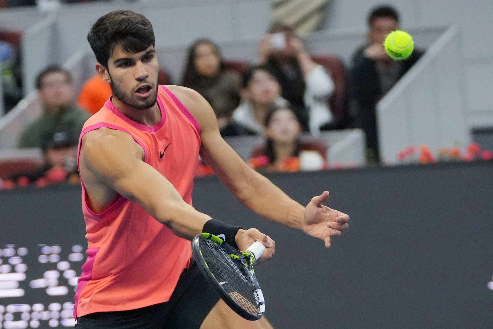 Carlos Alcaraz of Spain plays a forehand return against Jannik Sinner of Italy during their men's singles finals match of the China Open tennis tournament, at the National Tennis Center in Beijing, Wednesday, Oct. 2, 2024. (AP Photo/Achmad Ibrahim)