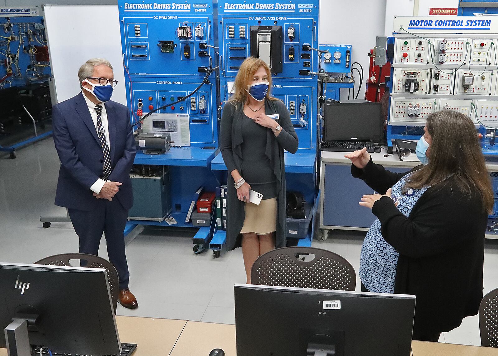 Clark State College Engineering Professor Nora Hatem, right, talks about one of the labs as she and President Dr. Jo Alice Blondin, center, give Governor Mike DeWine a tour of their Advanced Manufacturing Lab Monday. BILL LACKEY/STAFF