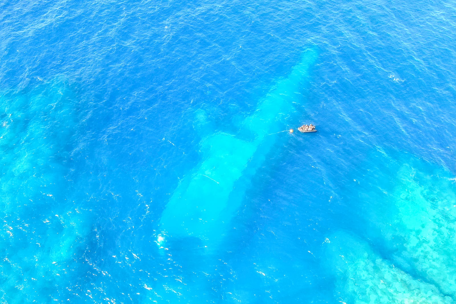 In this photo provided by the New Zealand Defence Force, divers survey the area around HMNZS Manawanui on the southern coast of Upulo, Samoa, after the Manawanui ran aground and sank on Oct. 6. (AC Jese Somerville/New Zealand Defence Force via AP)