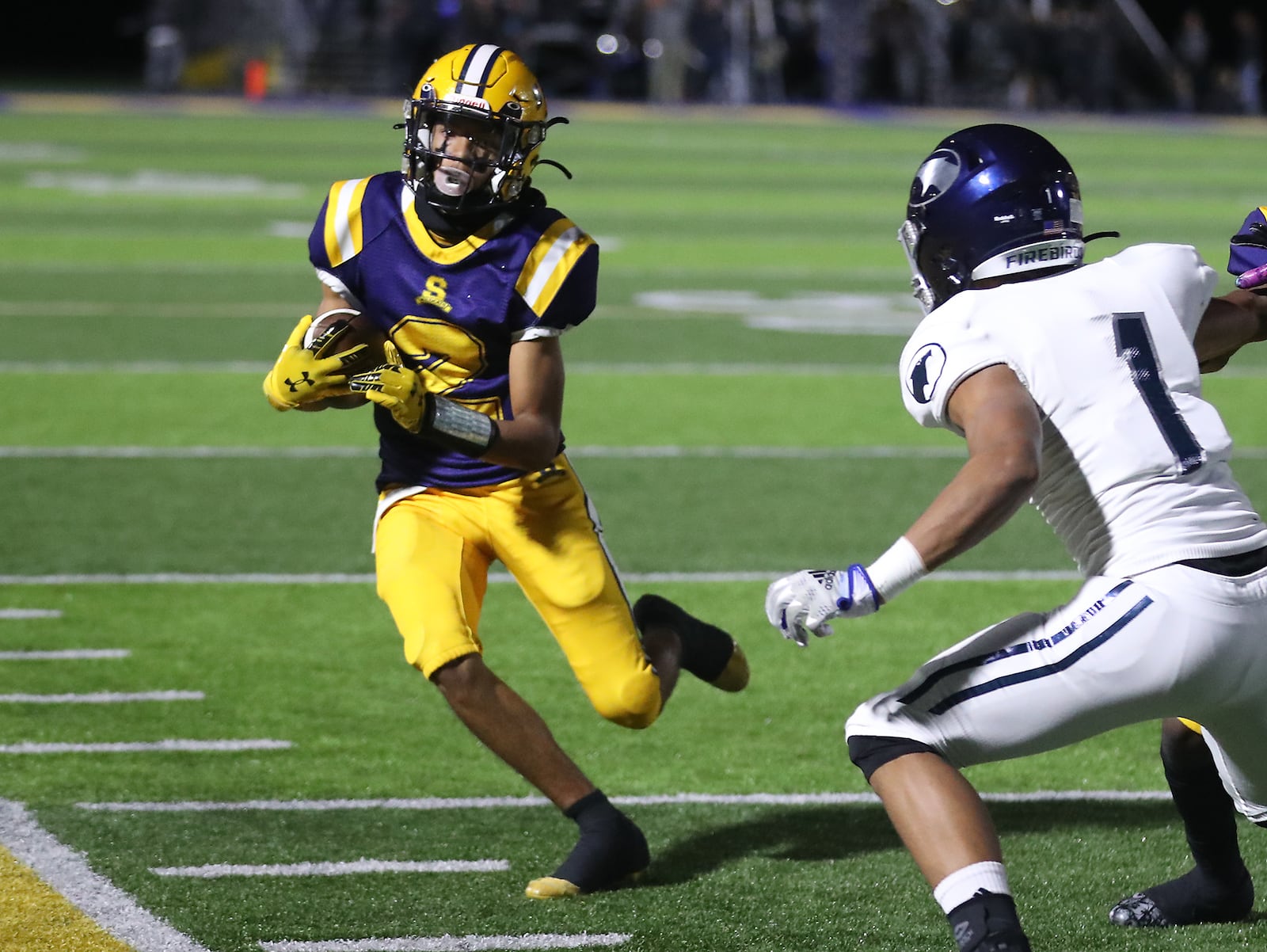 Springfield's Daylen Bradley runs out of bounds and avoids a tackle by Fairmont's Kamron Payne during Friday's game. BILL LACKEY/STAFF