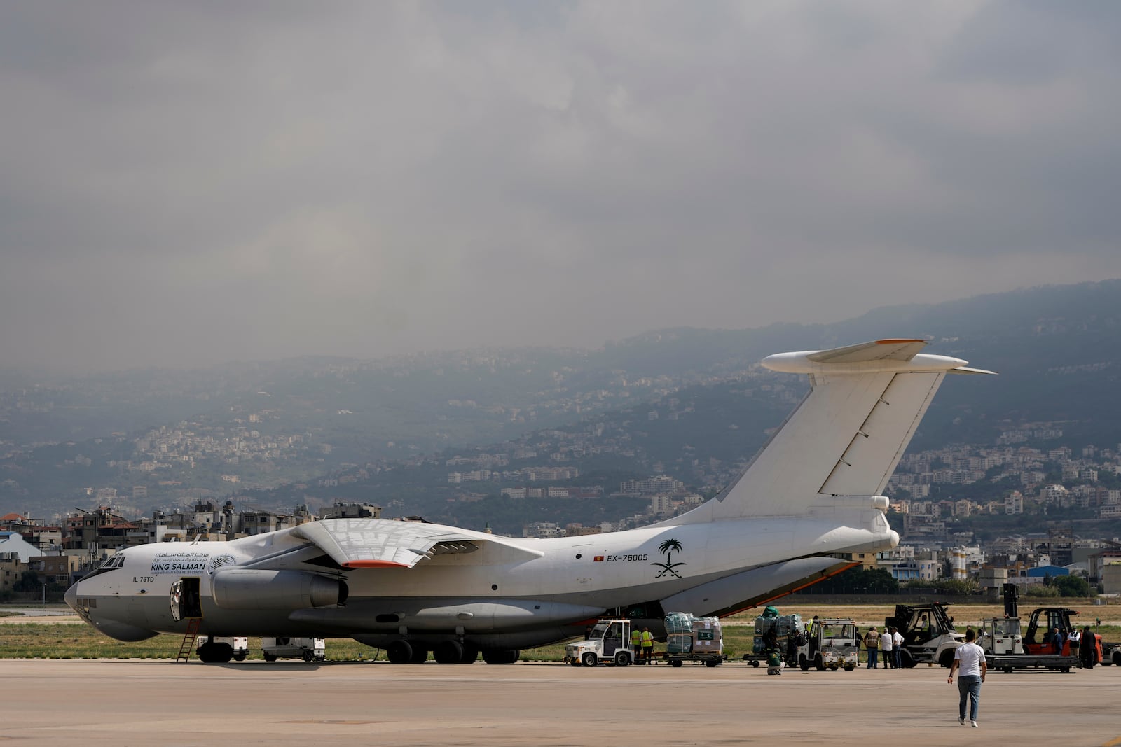 Workers unload Saudi medical aid boxes arriving at Beirut International airport, Lebanon, Sunday, Oct. 13, 2024. (AP Photo/Bilal Hussein)