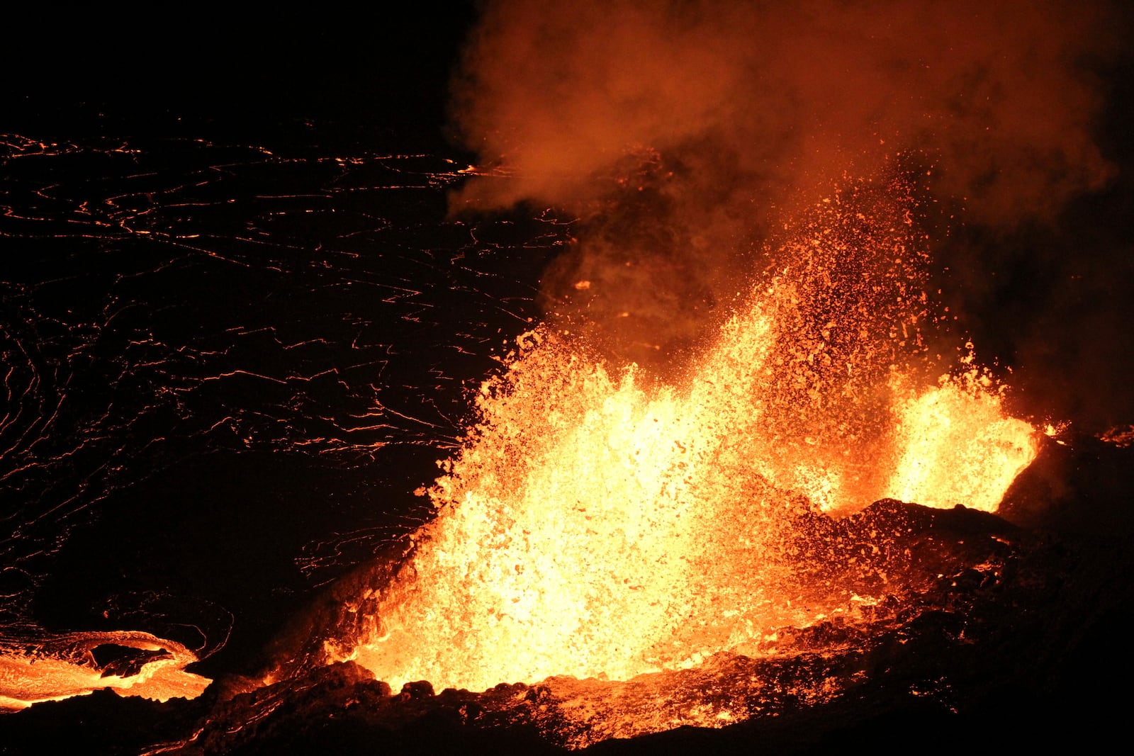 In this image provided the. the U.S. Geological Survey shows evening views of lava fountaining from Haleumaumau Crater at the summit of Kilauea volcano inside Hawaii Volcanoes National Park, Hawaii., on Tuesday, Feb. 11, 2025. (H Winslow/U.S. Geological Survey via AP)