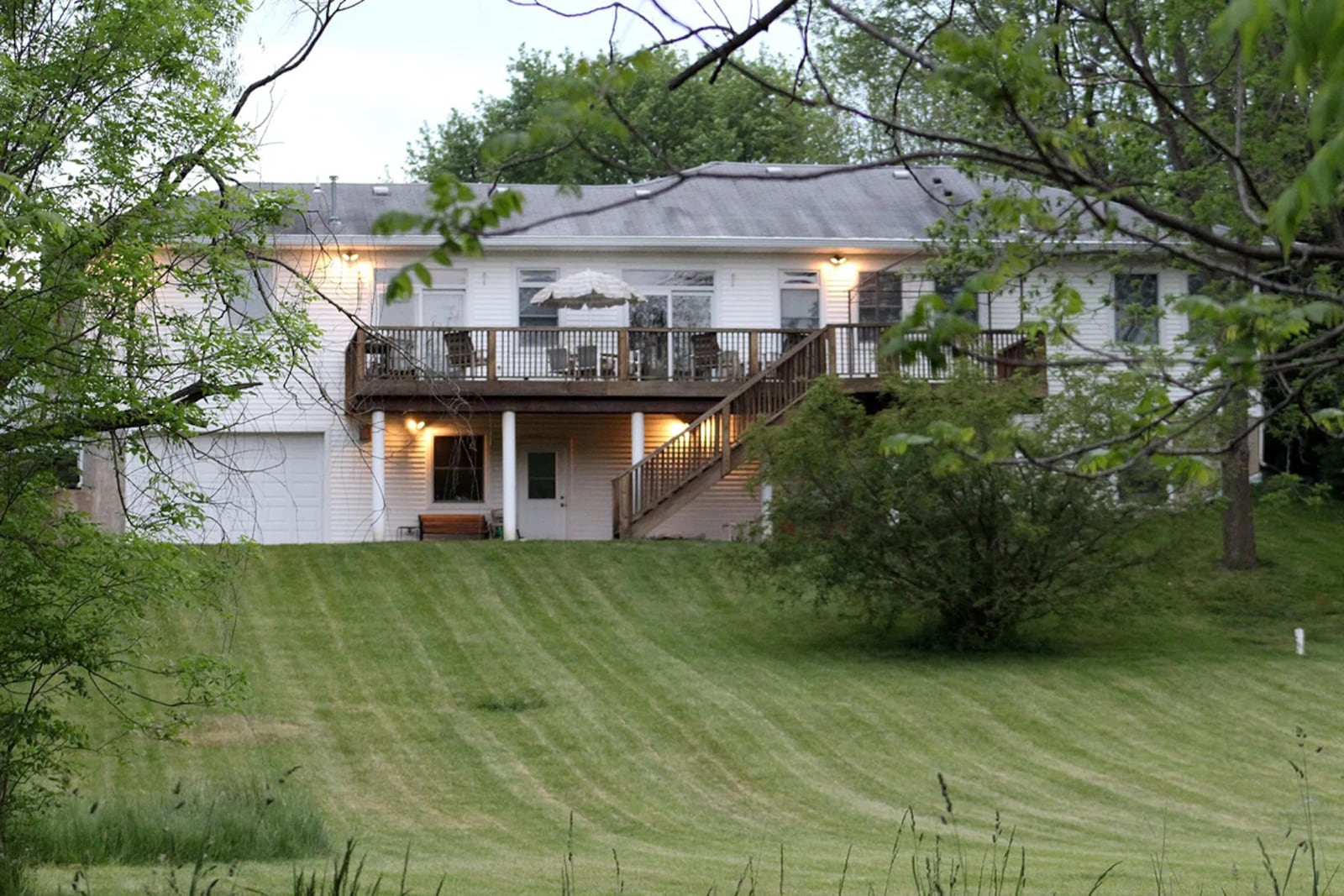 Mature trees and a 2-story wood rear deck overlook the 3.5-acre lot. There is also a concrete patio under the deck and a 1-car garage connected to the basement. CONTRIBUTED PHOTO