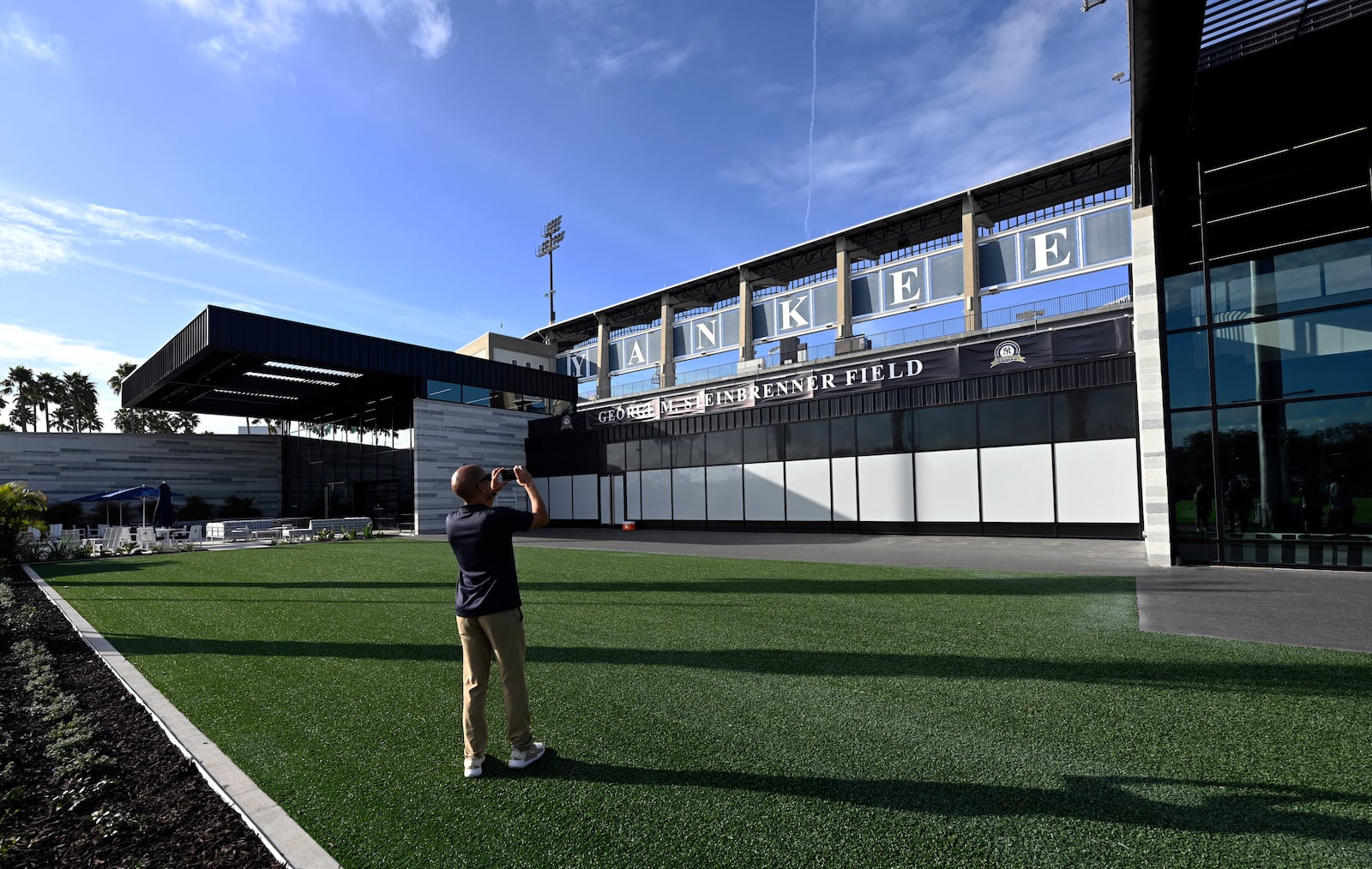 A member of the media photographs a recently completed wing of the New York Yankees clubhouse that lines the first base side of the stadium during a tour of the upgraded team spring training facilities Thursday, Feb. 13, 2025, at George M. Steinbrenner Field in Tampa, Fla. (AP Photo/Steve Nesius)