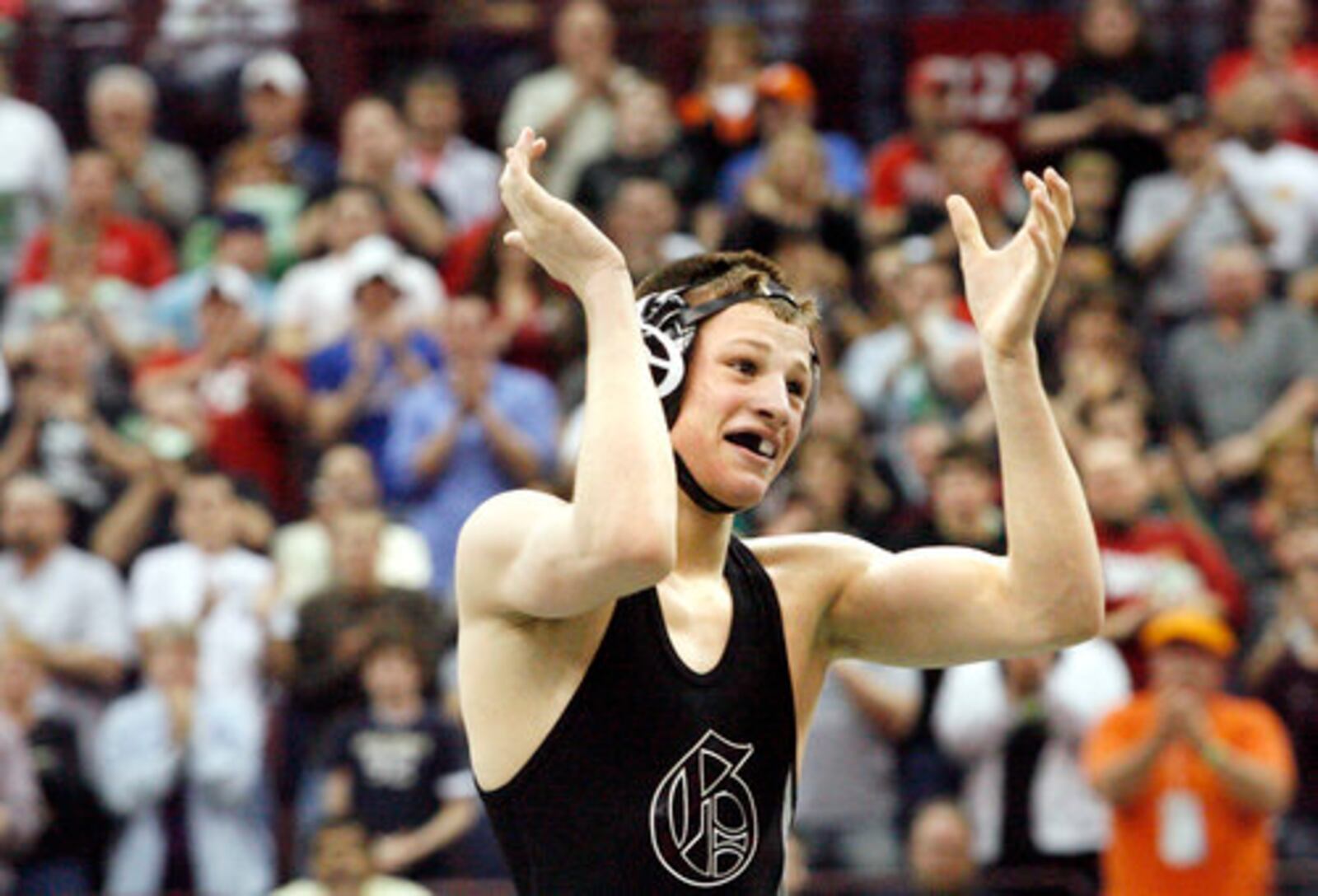 David Taylor of Graham claps as he receives a standing ovation from the crowd after defeating Manuel Cintron of Alliance at 135 lbs. to become a four-time Ohio state wrestling champion Saturday, March 7, 2009, at the Schottenstein Center in Columbus.