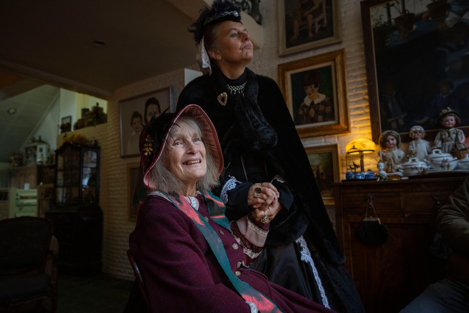 Emmy Strik, left, who started the Deventer Dickens Day, and Sandra Nieland who plays Queen Victoria, are interviewed as people in costumes from Charles Dickens' 19th-century English era take part in a Dickens Festival, in Deventer, Netherlands, Saturday, Dec. 14, 2024. (AP Photo/Peter Dejong)