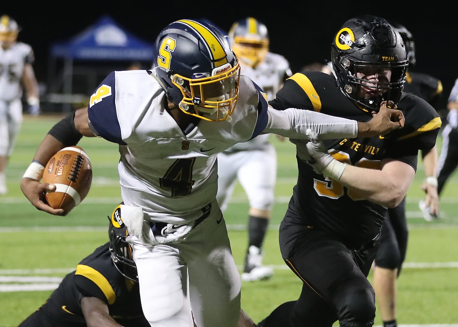 Springfield's Raheim Moss avoids a tackle by Centerville's Josh Zientko as he carries the ball for a Wildcats touchdown. BILL LACKEY/STAFF