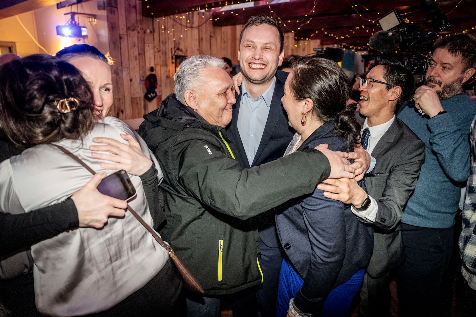 Chairman of Demokraatit, Jens-Frederik Nielsen, center, celebrates during the election party at Demokraatit by cafe Killut in Nuuk, early Wednesday, March 12, 2025. (Mads Claus Rasmussen/Ritzau Scanpix via AP)