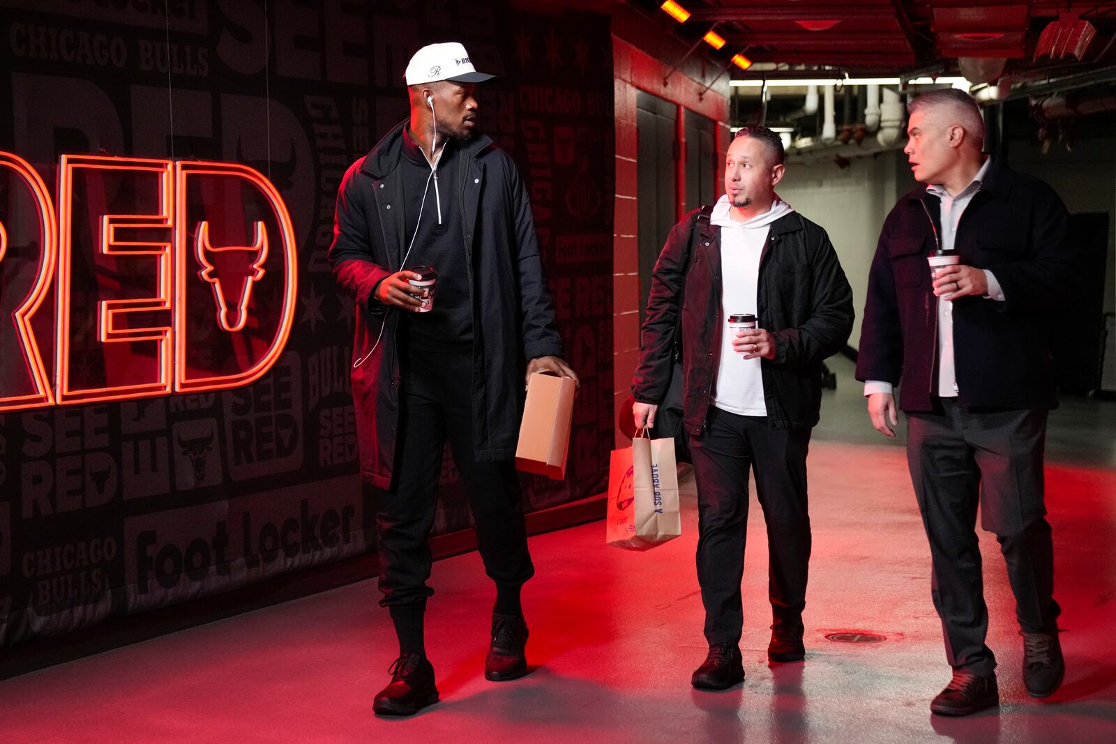 Golden State Warriors forward Jimmy Butler, left, arrives before an NBA basketball game against the Chicago Bulls, Saturday, Feb. 8, 2025, in Chicago. (AP Photo/Erin Hooley)